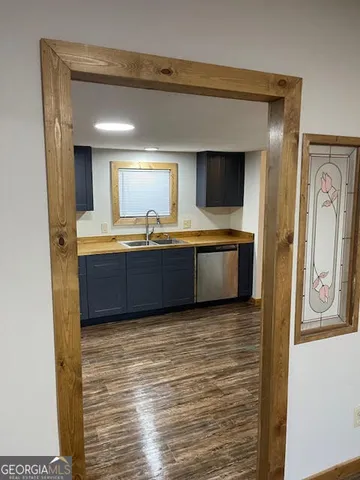 a view of kitchen with sink and window