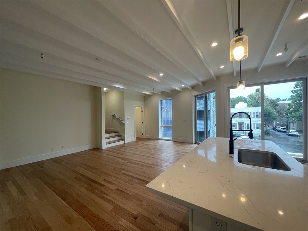65 Cameron Street, Unit 4 Brookline, MA 02445 - Photo 1 of 13 a view of a kitchen with a sink and window