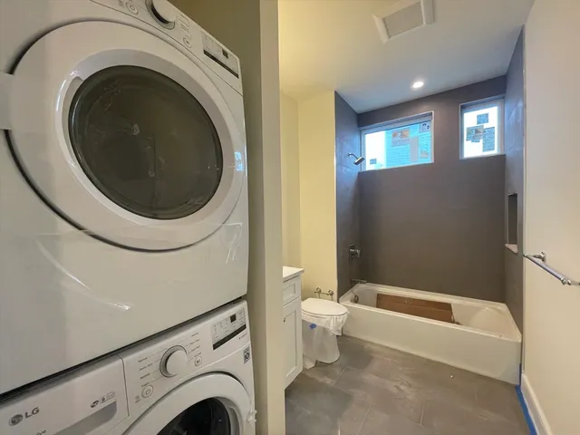 a view of bathroom with washing machine and bathtub