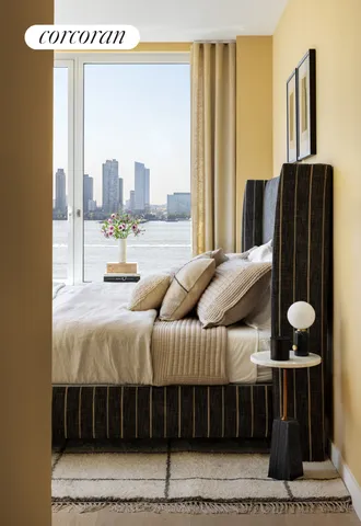 a bedroom with a large bed and a large window