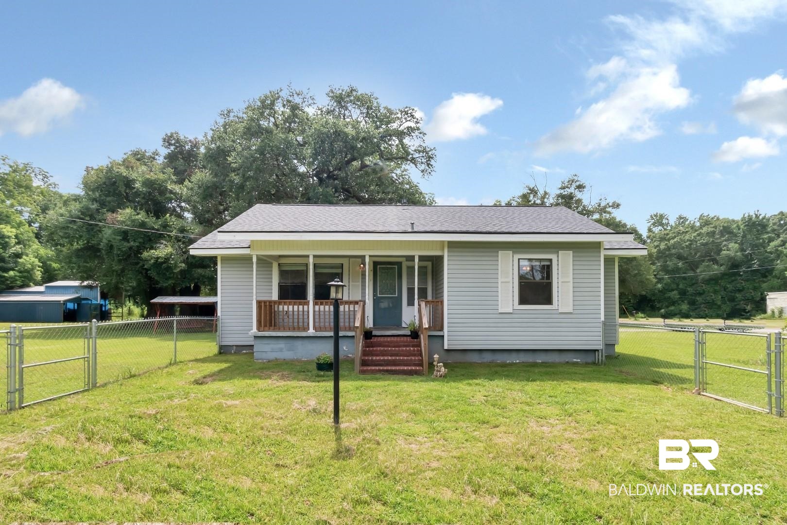 12751 Zanzibar Road Grand Bay, AL 36541 - Photo 1 of 30 Bungalow-style house featuring a front lawn and covered porch