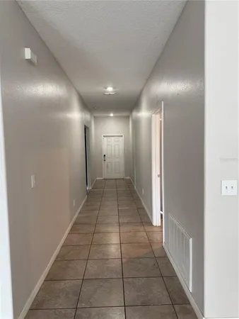 a kitchen with stainless steel appliances granite countertop a refrigerator a sink a microwave oven and a granite counter top