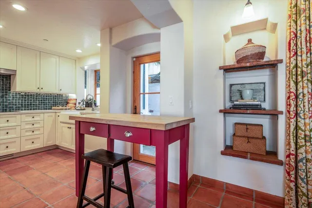 a kitchen with a stove a sink and a refrigerator