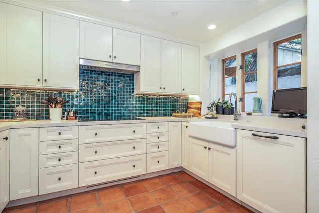 a kitchen with cabinets stainless steel appliances and a window