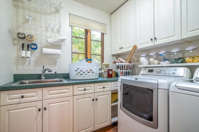 a kitchen with granite countertop white cabinets and white appliances