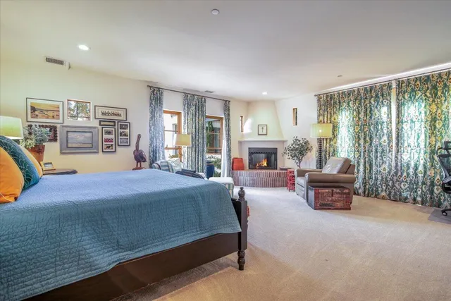 a bedroom with a bed couch and a large window