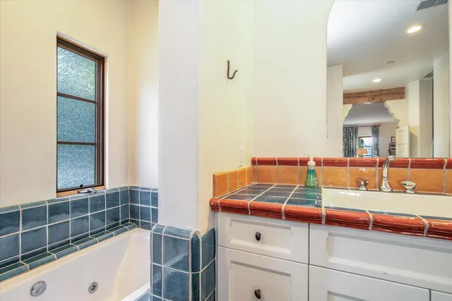 a bathroom with a tub and a sink