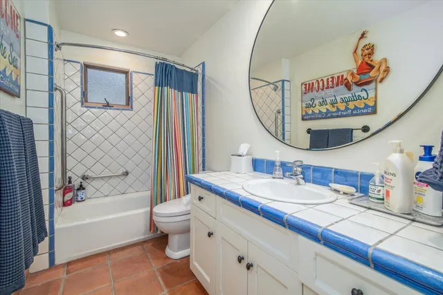 a bathroom with a sink a mirror a bathtub and a toilet