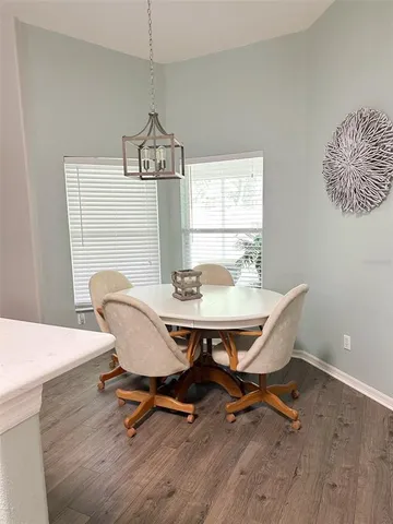 a dining room with furniture and window