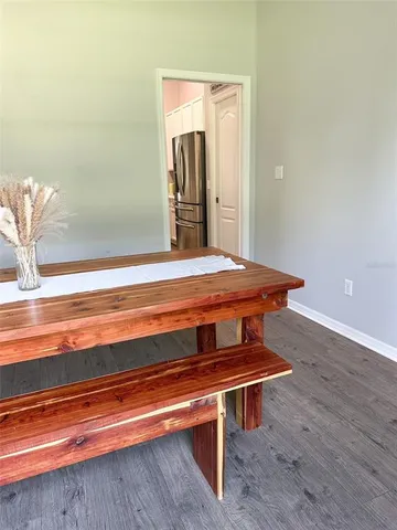 a room with wooden floor and table