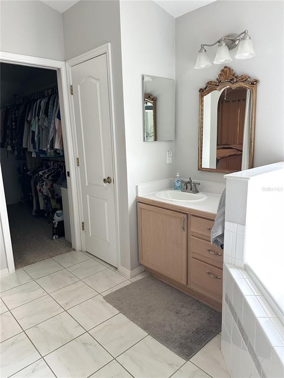 33632 Wesley Road Eustis, FL 32736 - Photo 25 of 34 a bathroom with a sink and a mirror