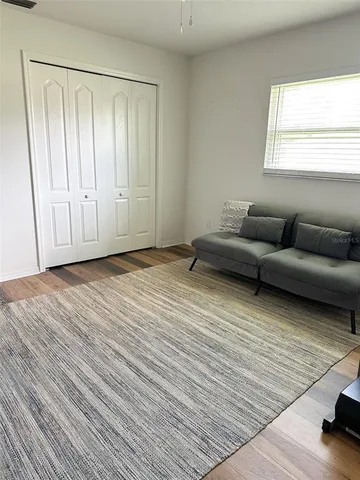 a view of a livingroom with furniture and wooden floor