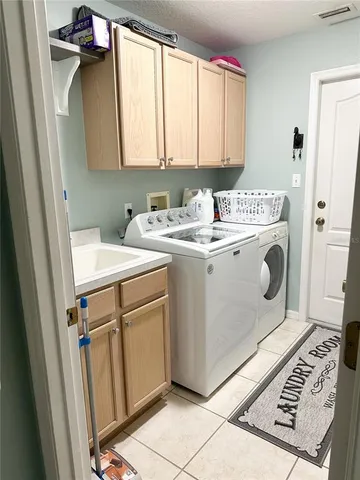 a utility room with a sink a washer and dryer