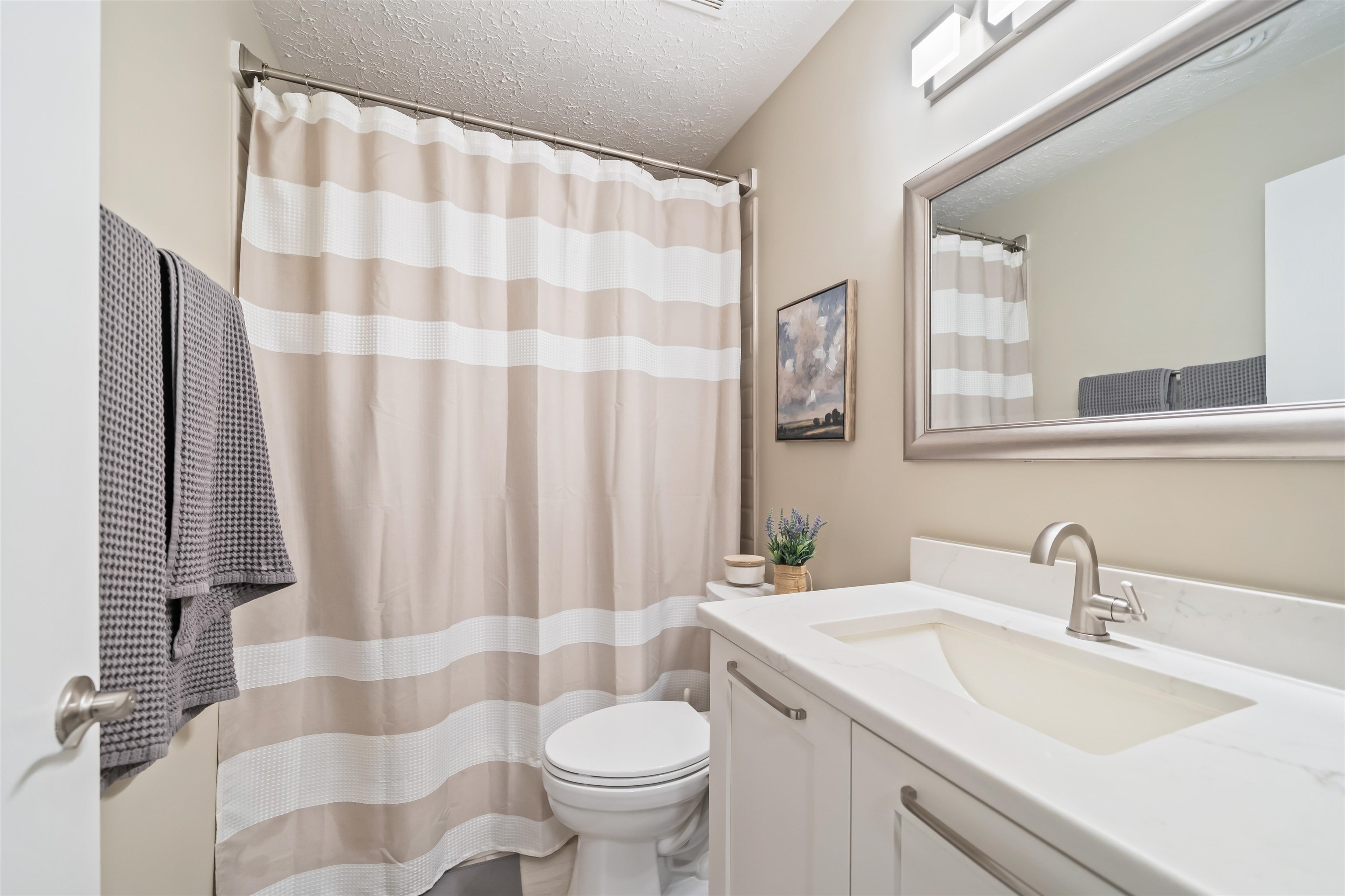 6943 Fords Station Road, Unit 64 Germantown, TN 38138 - Photo 23 of 30 White vanity with integrated sink, brushed nickel faucet, and framed mirror