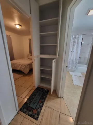 a bedroom with a bed and a mirror