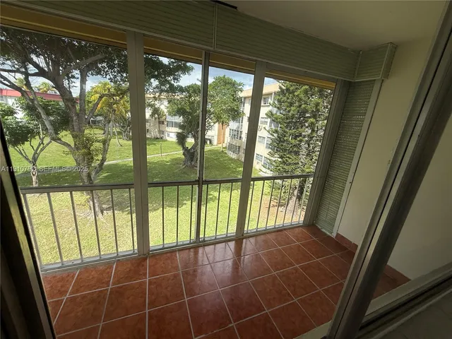 a view of empty room with large windows