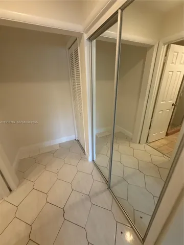 a view of a kitchen with granite countertop cabinets and refrigerator