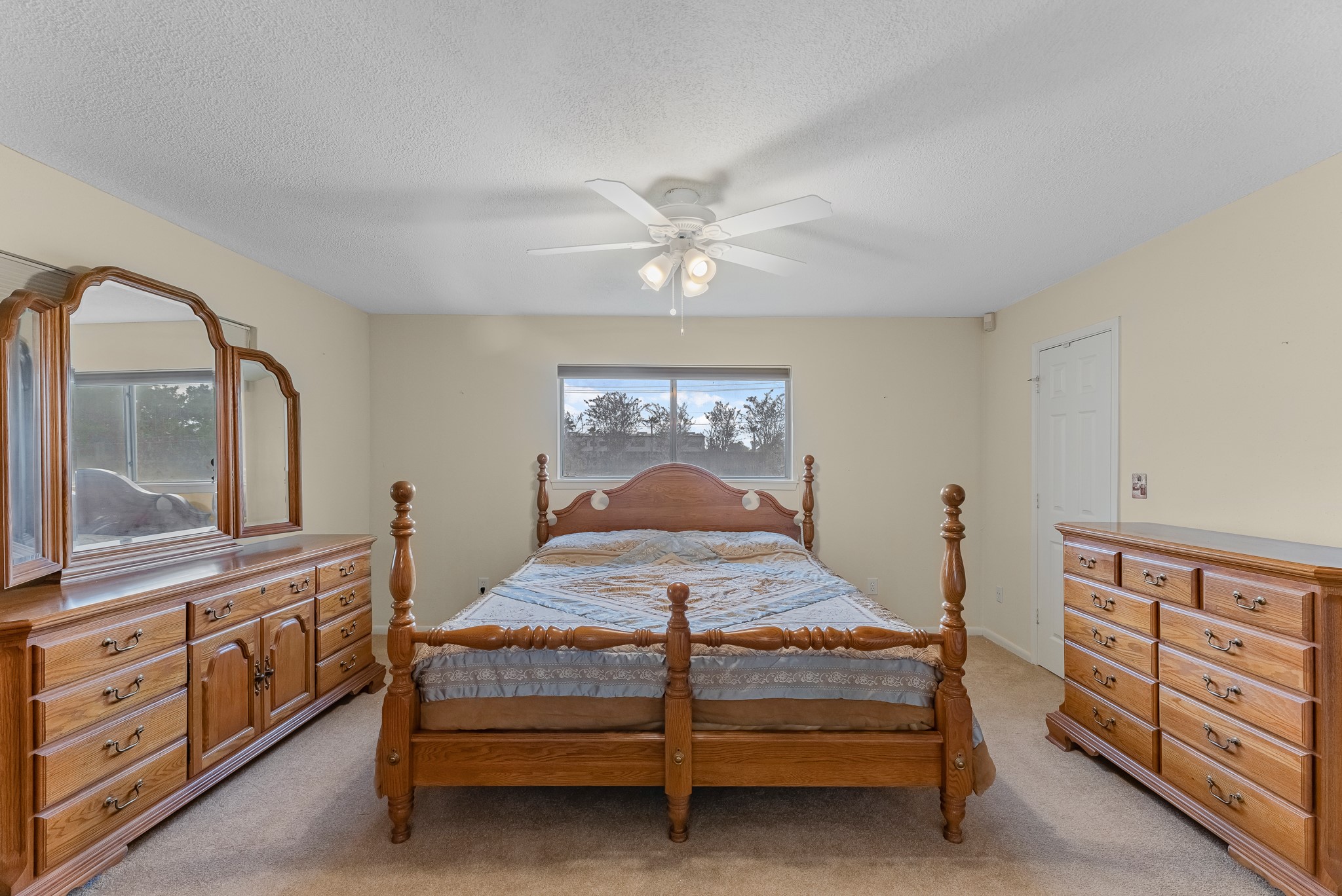 7315 Pine Street Manvel, TX 77578 - Photo 35 of 50 a bedroom with a bed and dresser with mirror