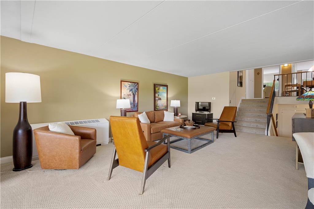 1150 Bower Hill Road, Unit 514B Pittsburgh, PA 15243 - Photo 11 of 44 a living room with furniture and a lamp
