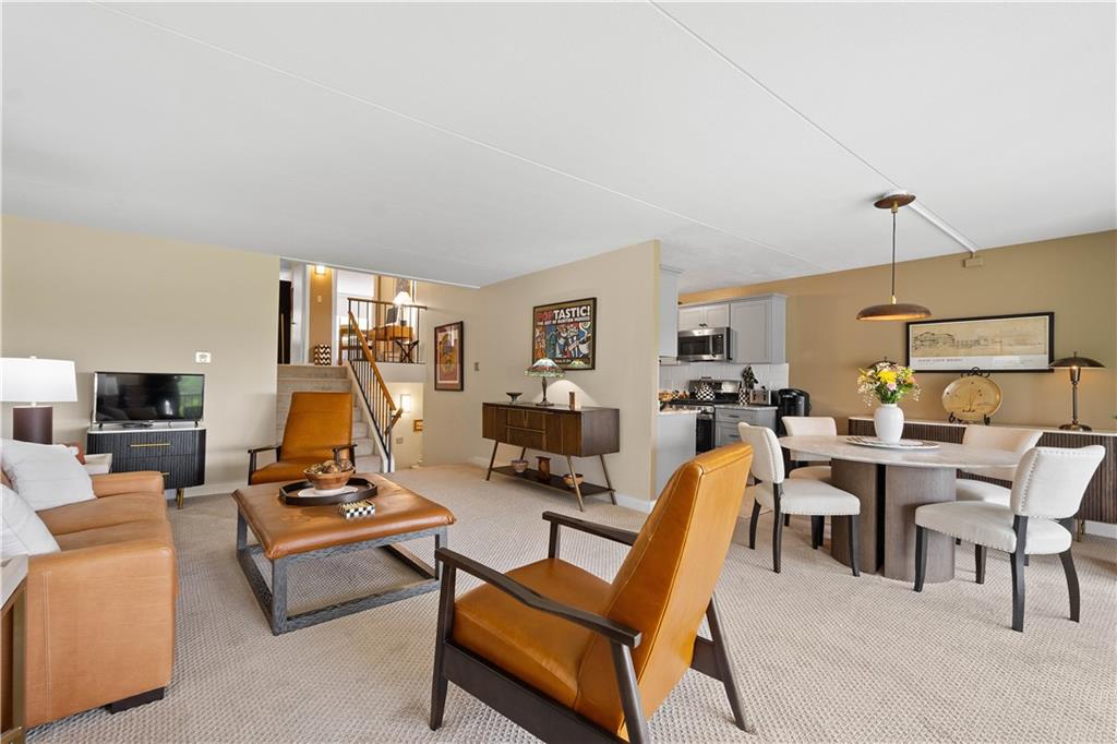 1150 Bower Hill Road, Unit 514B Pittsburgh, PA 15243 - Photo 12 of 44 a living room with furniture a flat screen tv and a table