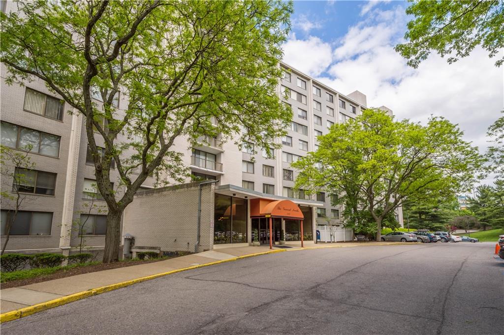 1150 Bower Hill Road, Unit 514B Pittsburgh, PA 15243 - Photo 2 of 44 a front view of a house with a yard and garage