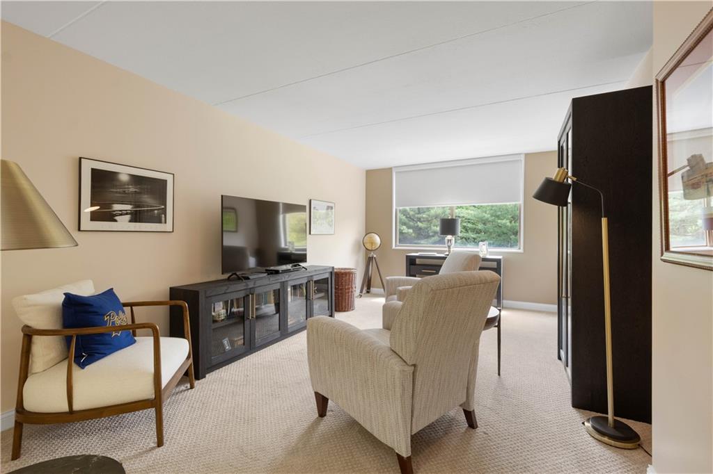 1150 Bower Hill Road, Unit 514B Pittsburgh, PA 15243 - Photo 21 of 44 a living room with furniture a flat screen tv and a large window