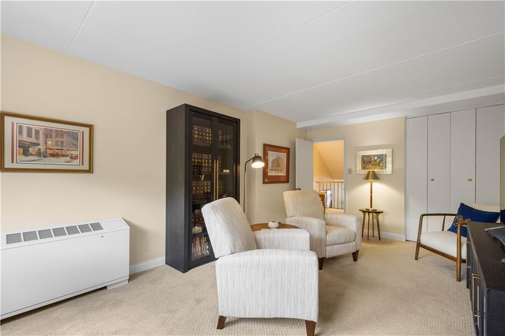 1150 Bower Hill Road, Unit 514B Pittsburgh, PA 15243 - Photo 22 of 44 a living room with furniture and a lamp