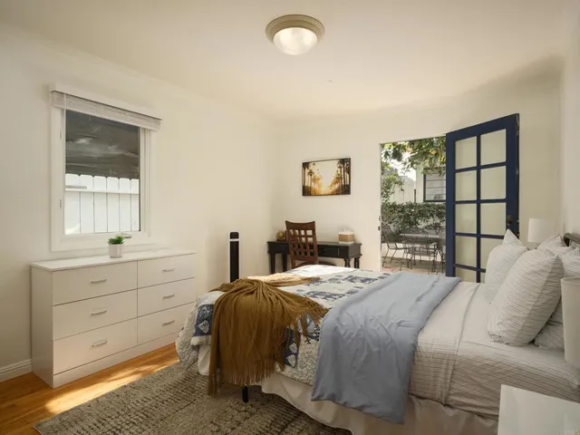 a bedroom with a bed and a window