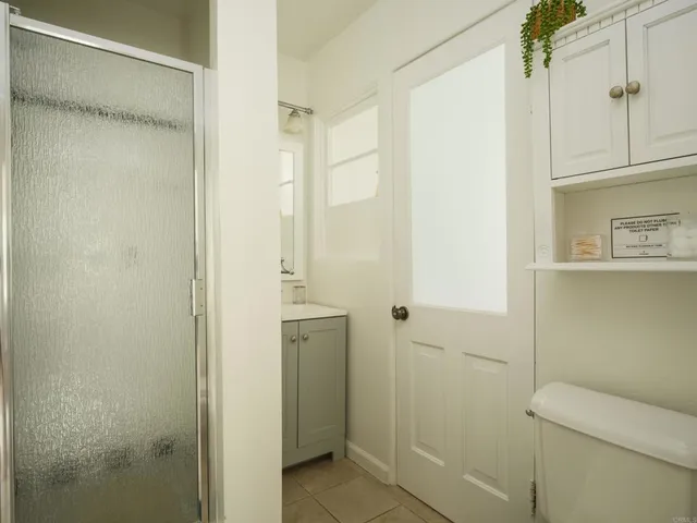 a bathroom with a shower and a toilet