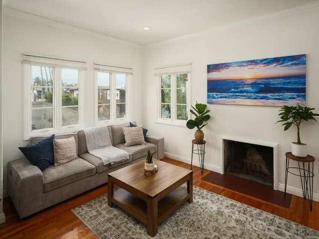 a living room with furniture a fireplace and windows