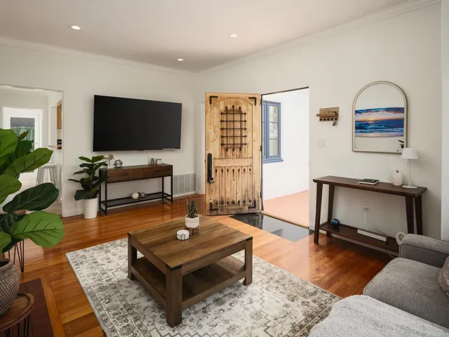 a living room with furniture and a flat screen tv