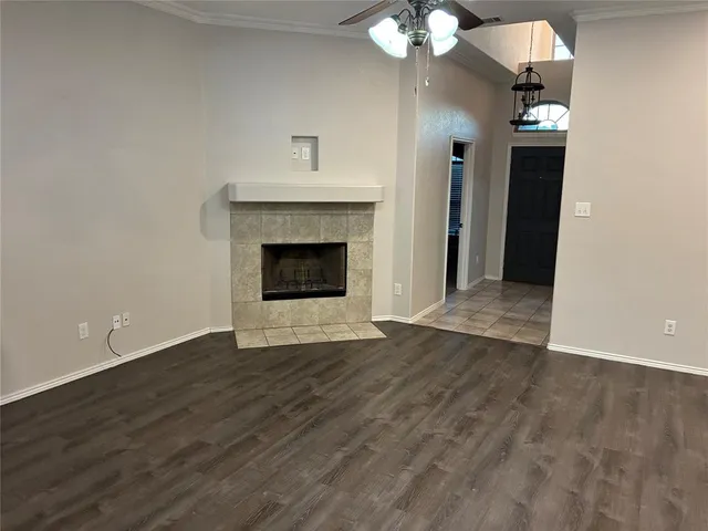 wooden floor fireplace and windows in an empty room