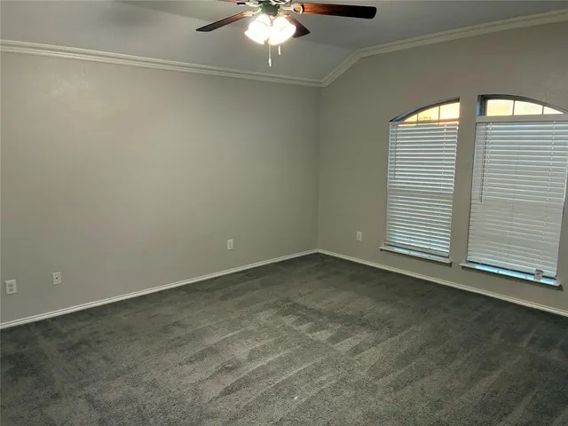 a view of a room with a ceiling fan and a window