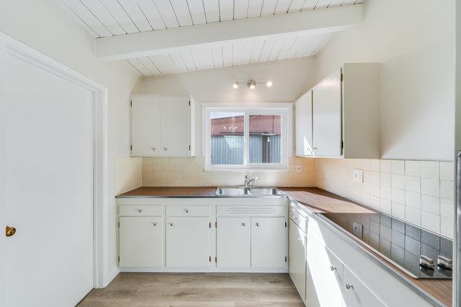 28207 Rochelle Avenue Hayward, CA 94544 - Photo 12 of 27 a kitchen with a sink cabinets and window