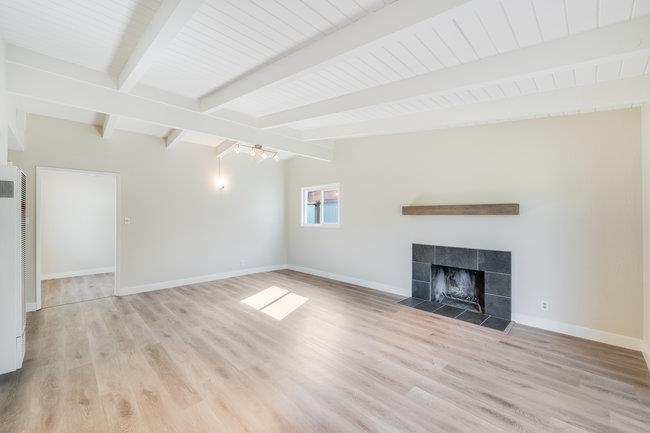 28207 Rochelle Avenue Hayward, CA 94544 - Photo 9 of 27 a view of an empty room with wooden floor fireplace and a window