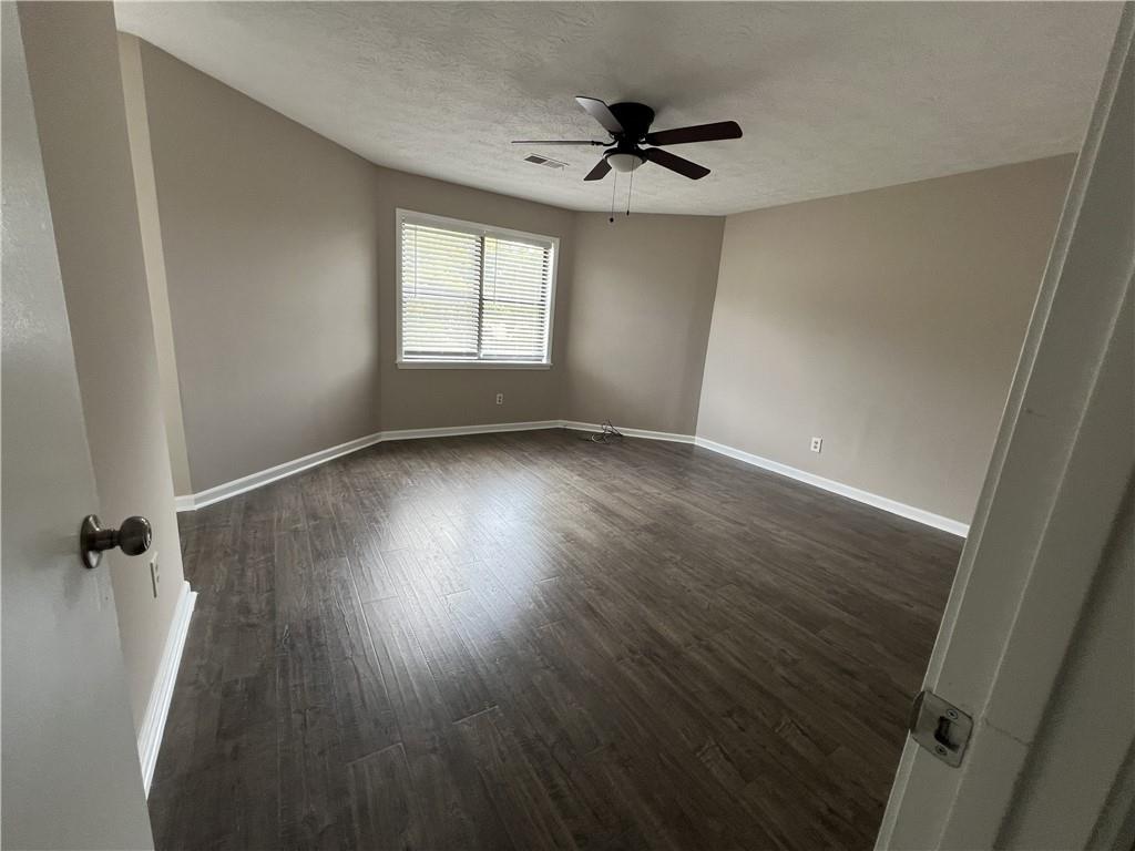 893 Sandune Drive Norcross, GA 30093 - Photo 4 of 14 wooden floor in an empty room with a window