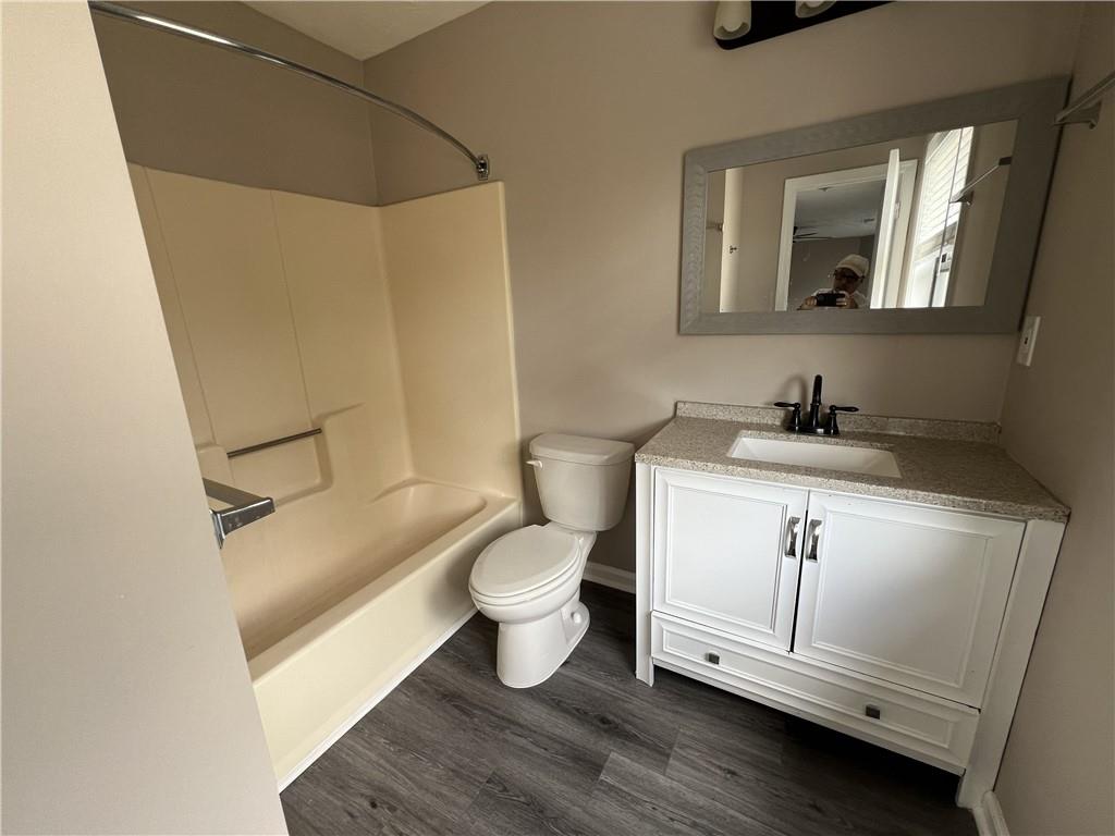 893 Sandune Drive Norcross, GA 30093 - Photo 5 of 14 a bathroom with a toilet sink and mirror