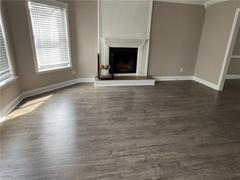 893 Sandune Drive Norcross, GA 30093 - Photo 10 of 14 an empty room with wooden floor and fireplace