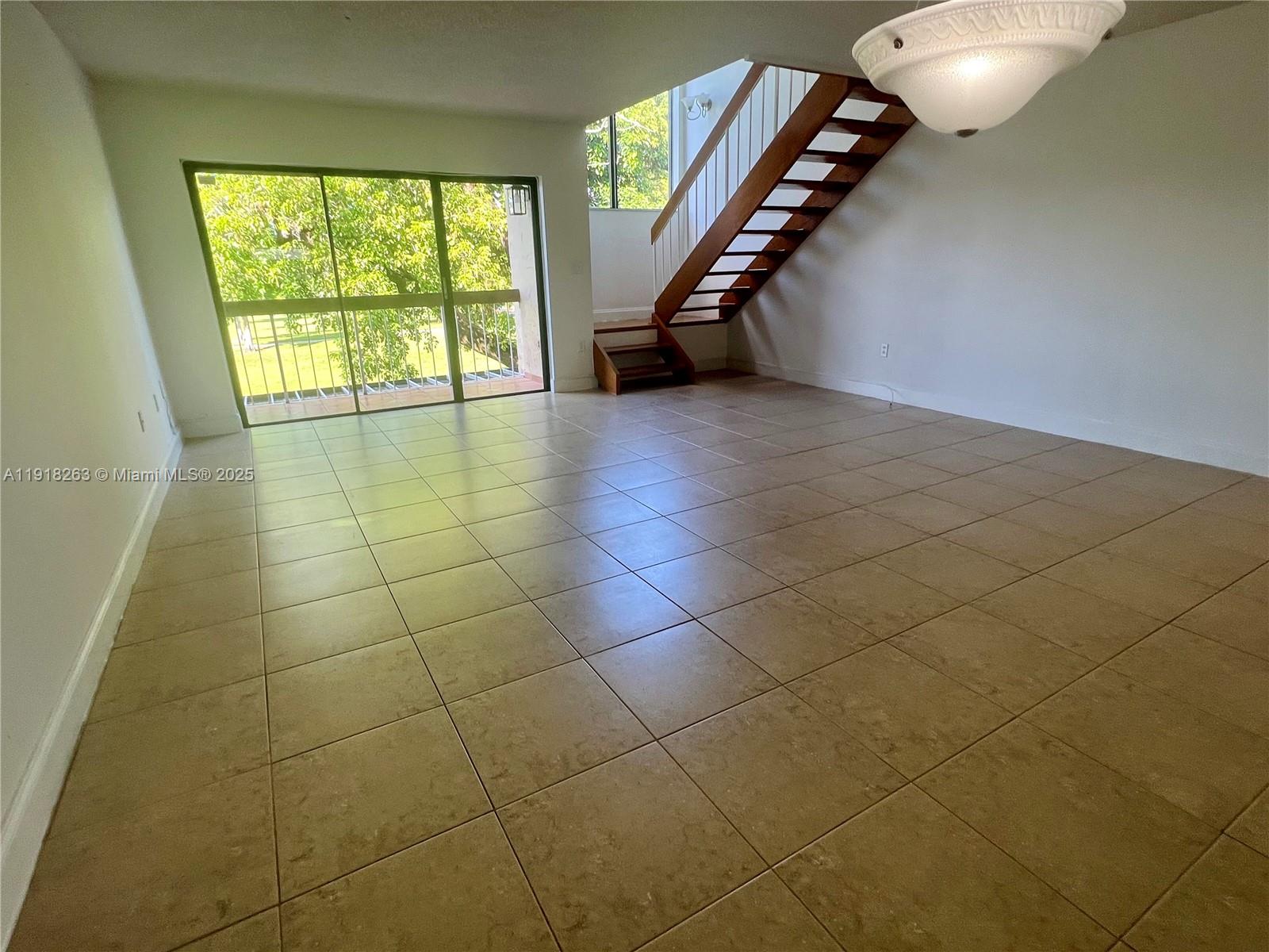 9961 Northwest 9th St Circle, Unit 818 Miami, FL 33172 - Photo 1 of 25 a view of an empty room with a window