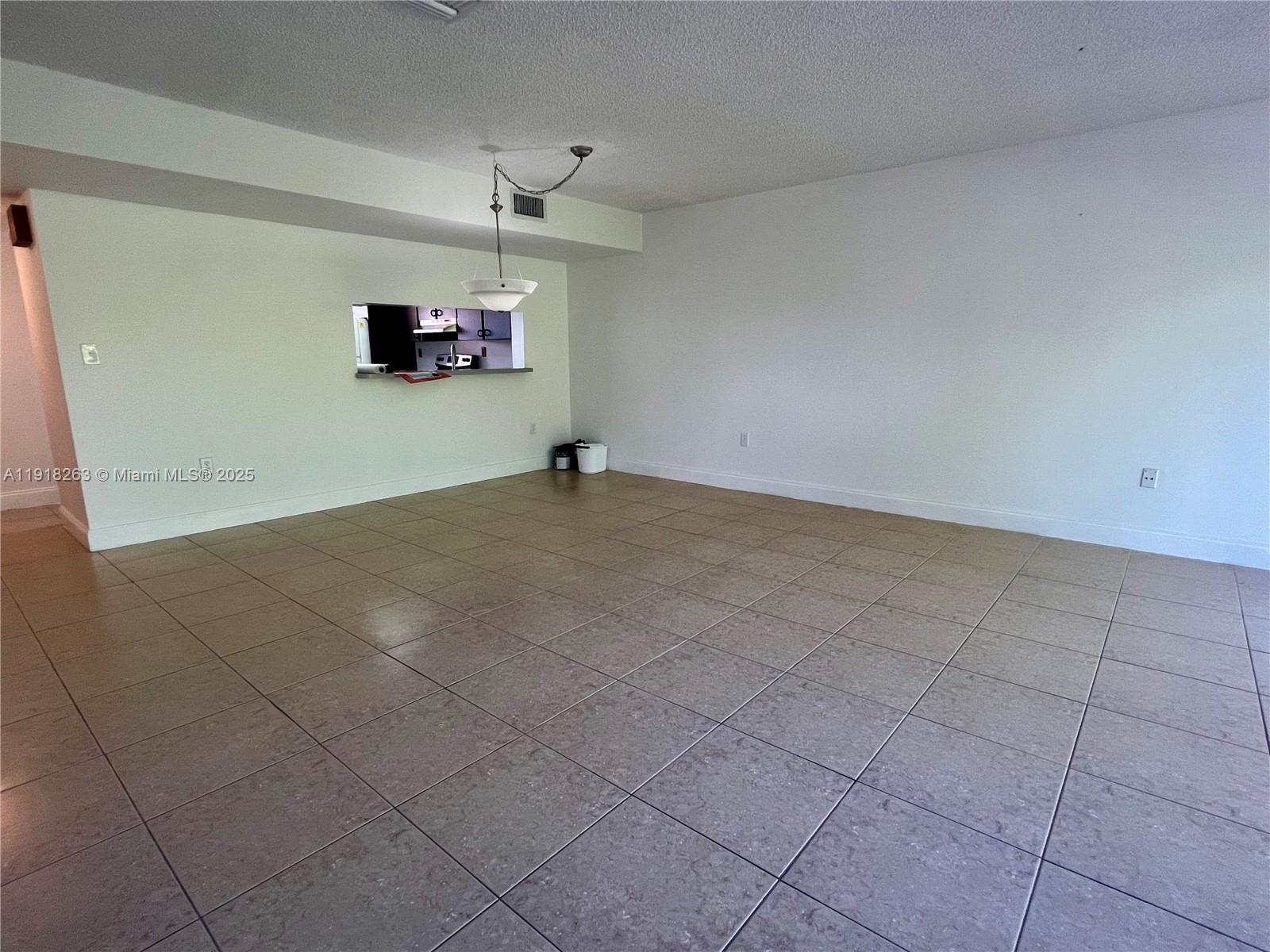 9961 Northwest 9th St Circle, Unit 818 Miami, FL 33172 - Photo 11 of 25 a view of a livingroom with a kitchen