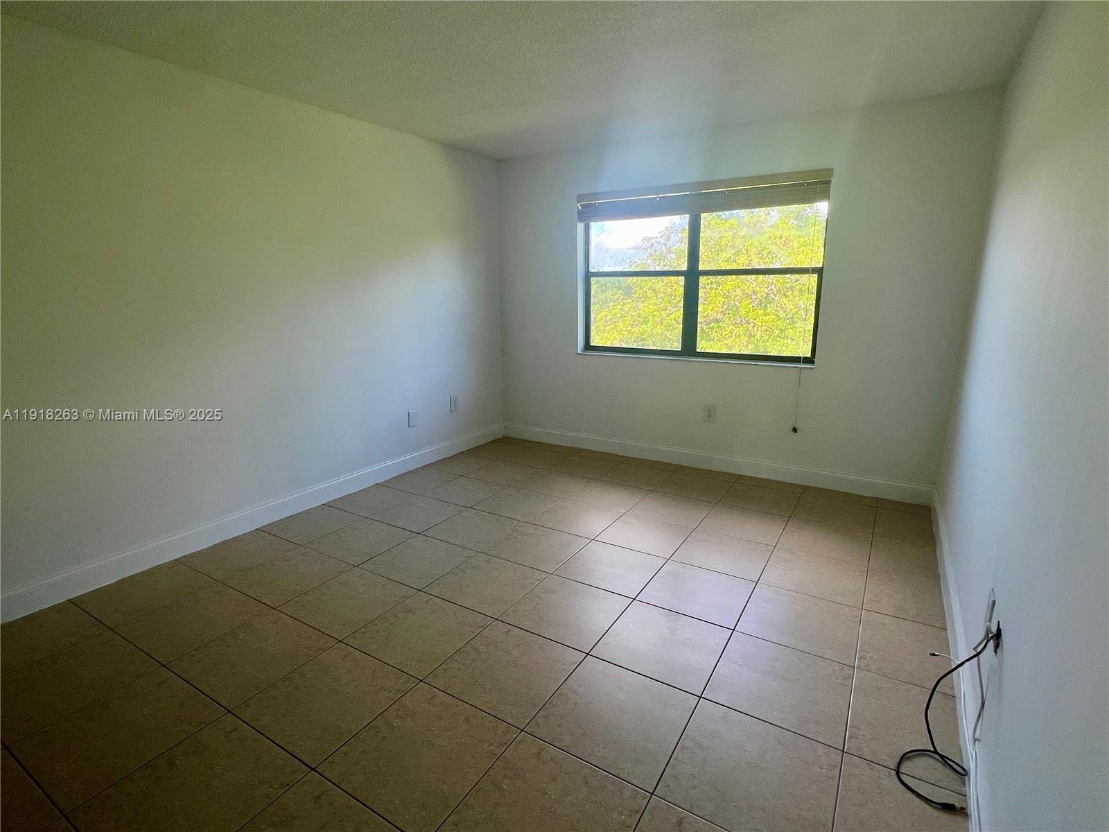 9961 Northwest 9th St Circle, Unit 818 Miami, FL 33172 - Photo 14 of 25 a view of an empty room with a window