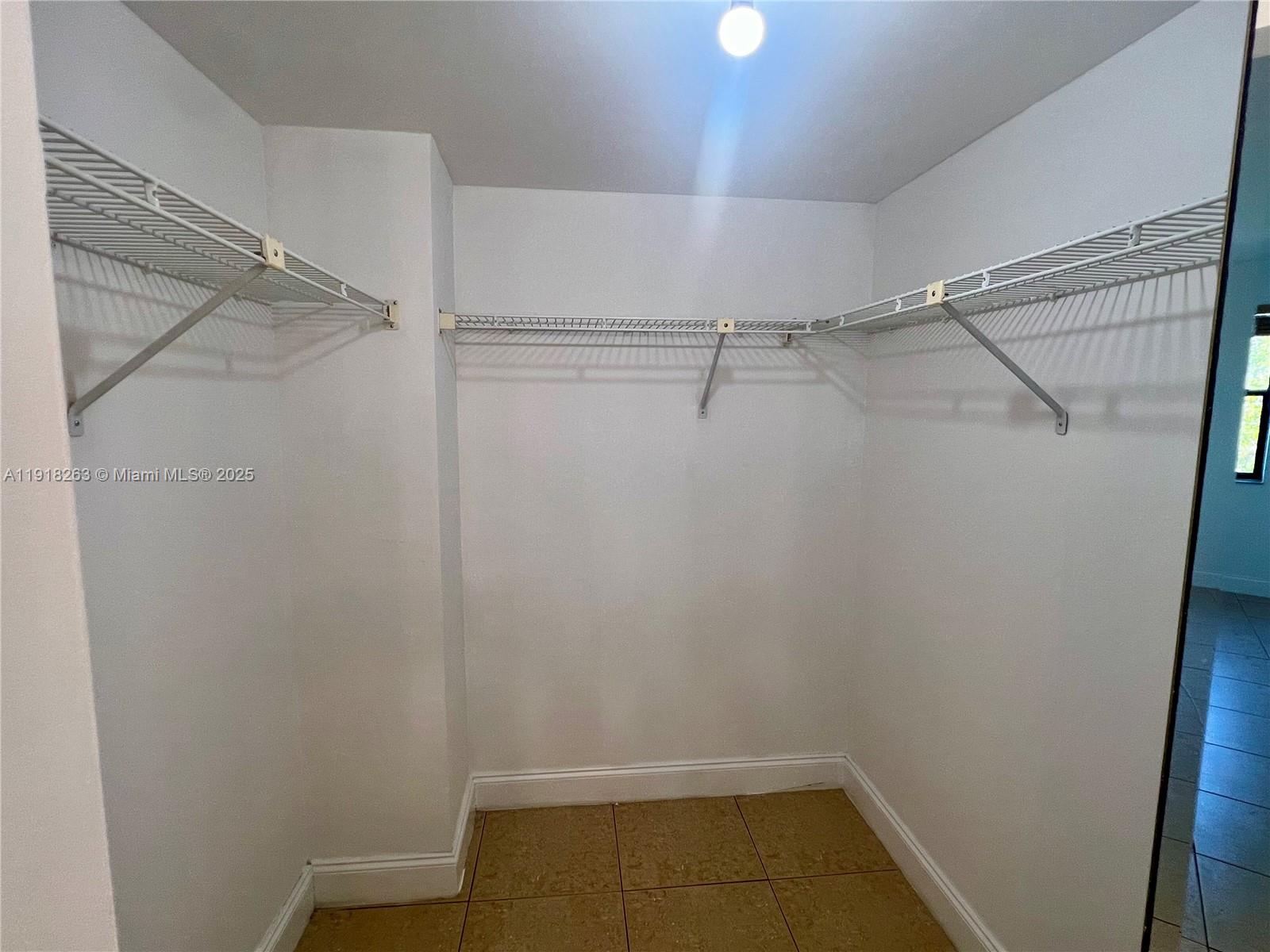 9961 Northwest 9th St Circle, Unit 818 Miami, FL 33172 - Photo 17 of 25 a view of a room with racks on the wall