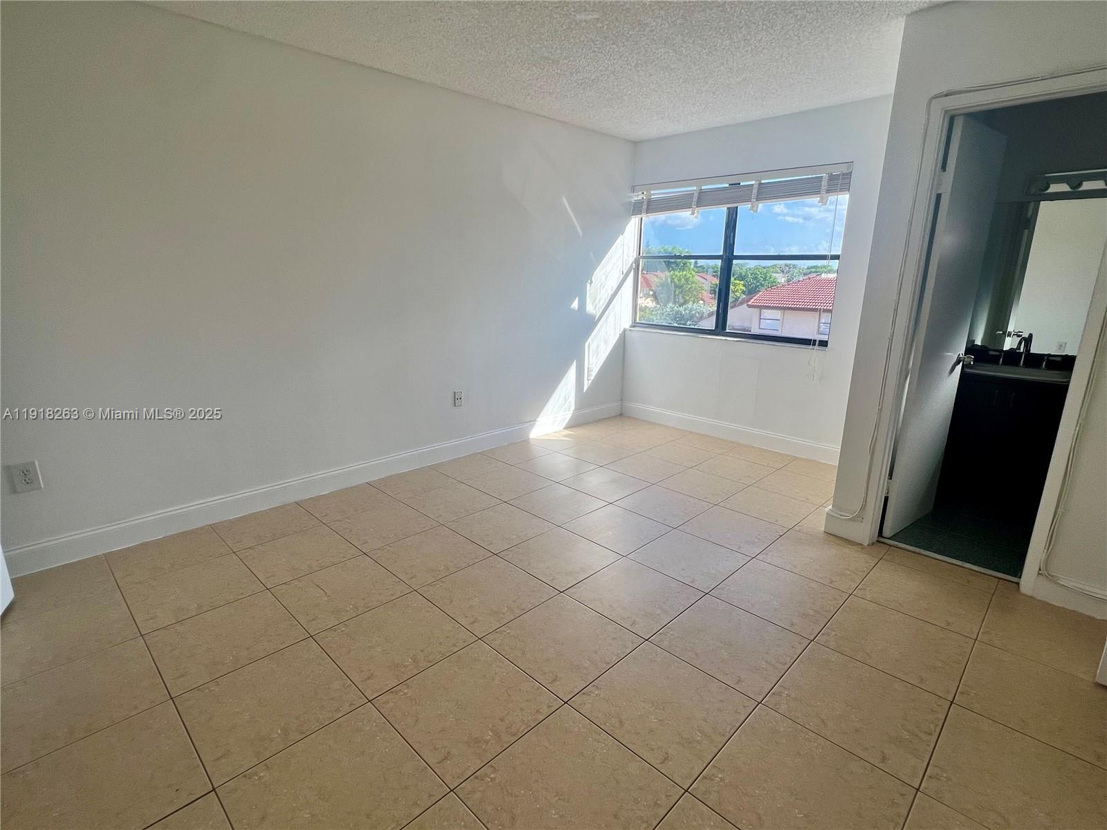9961 Northwest 9th St Circle, Unit 818 Miami, FL 33172 - Photo 20 of 25 an empty room with windows