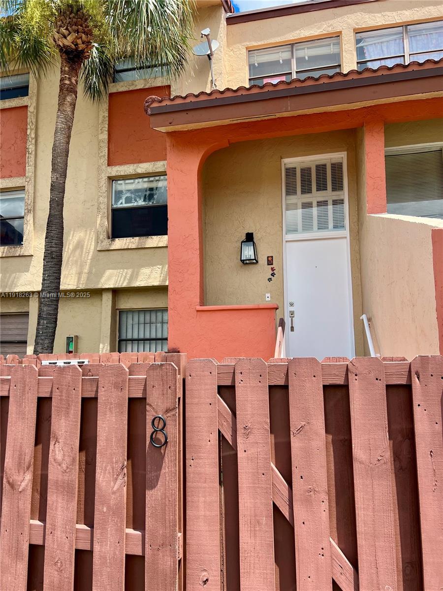 9961 Northwest 9th St Circle, Unit 818 Miami, FL 33172 - Photo 2 of 25 a front view of a building with glass windows