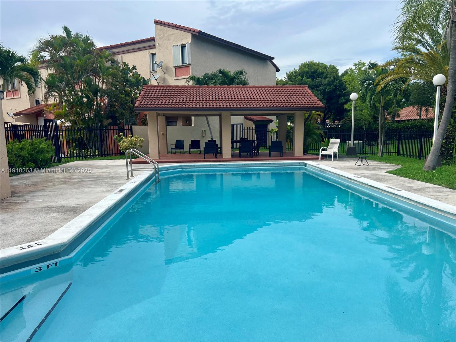 9961 Northwest 9th St Circle, Unit 818 Miami, FL 33172 - Photo 4 of 25 a view of a swimming pool with sitting area