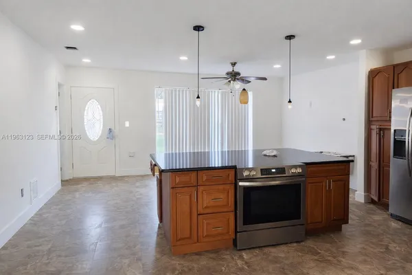 a kitchen with stainless steel appliances granite countertop a stove and a refrigerator