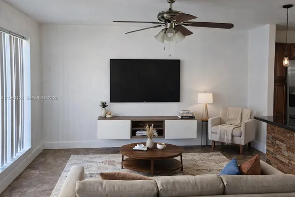 a living room with furniture and a flat screen tv