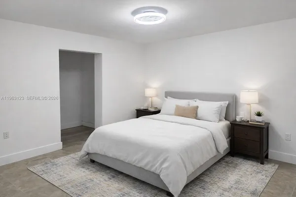 a bedroom with a bed and lamp