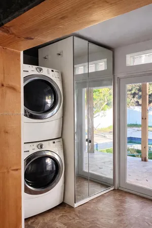 a view of a hallway with washer and dryer