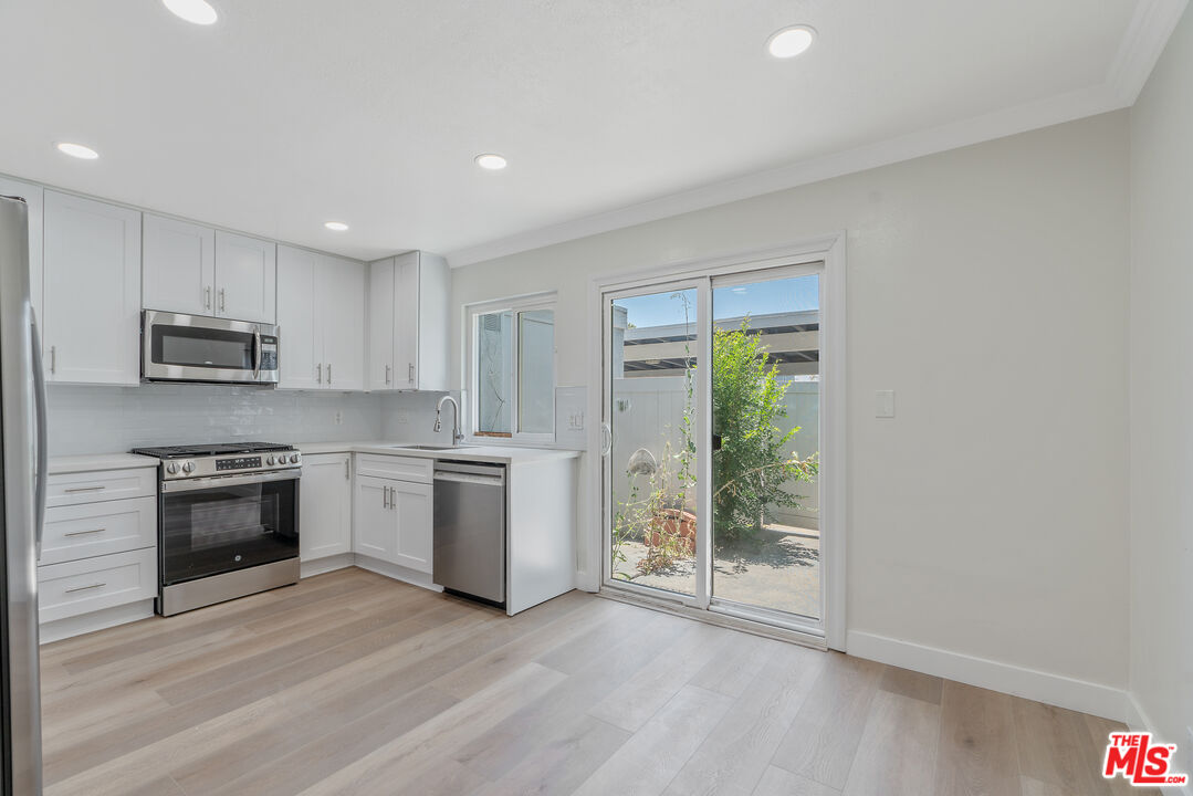 46 Eagle Point Irvine, CA 92604 - Photo 11 of 30 a kitchen with stove a sink and a microwave